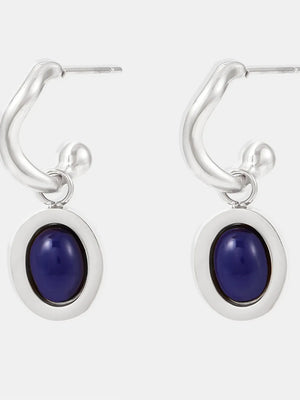 Sculptural hoop earrings with oval blue stone inlays and silver hardware.