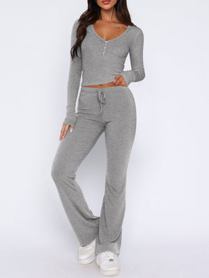 Gray ribbed loungewear set with long sleeve crop top and flared pants with drawstring waist