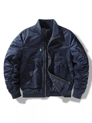 Men's blue bomber jacket with full zip, ruched sleeves, and zippered pockets.