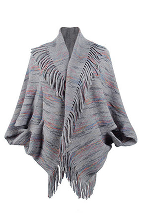 Textured knit cape in charcoal with colorful stripes and fringe trim.
