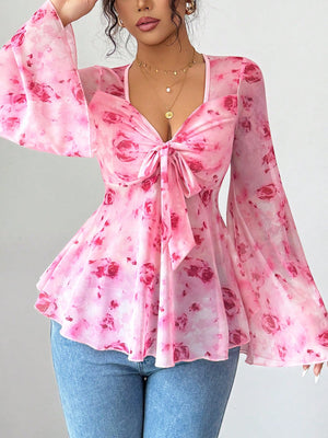 Pink floral chiffon blouse with tie-front and bell sleeves.