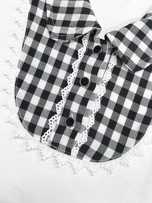 Black and white gingham maternity shirt with lace trim collar and decorative buttons.