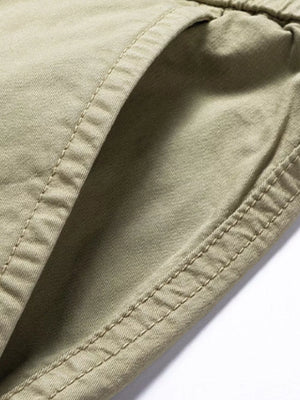 Khaki cargo joggers with flap pocket detail and visible stitching.