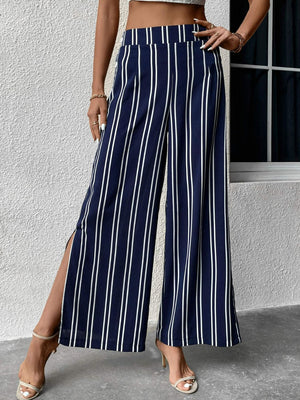 Dark blue palazzo trousers with white vertical stripes and side slits.