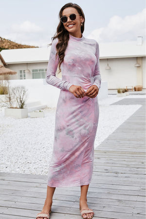 Tie-dye ruched midi dress with mock neck in blush pink, long sleeves, and a side slit.