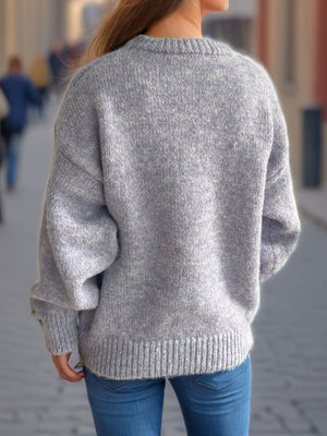 Oversized crewneck sweater in a textured knit, light grey marled acrylic, with ribbed cuffs and hem.
