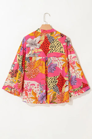 Patchwork floral print blouson sleeve blouse in strawberry pink with a ruffled hem.