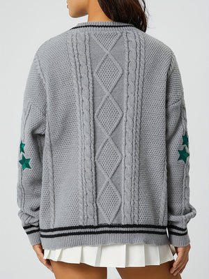 Gray cable knit cardigan with diamond pattern, stars on sleeve, and striped trim.