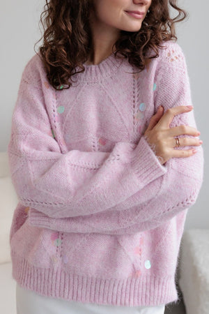 Blush pink diamond knit sweater with scattered pastel sequins and open knit details.