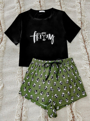 Black graphic tee with "friday" text and green panda print shorts.