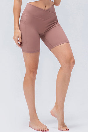 Cross-waist bike shorts in Dusty Pink with side pockets.