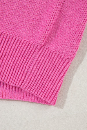 Fuchsia pink knit sweater with ribbed details and puff sleeves.