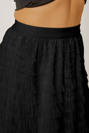 Black tiered tulle maxi skirt with ruffled layers and elastic waistband.