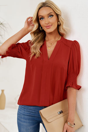 Deep Red V-neck blouse with smocked puff sleeves and a pleated front.