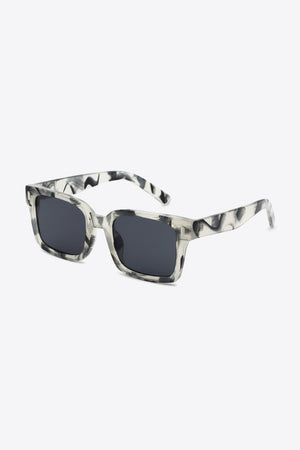 Marble effect rectangular sunglasses with dark lenses and bold frames.