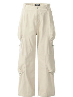 Beige men's cargo pants with multiple large pockets and zipper details.