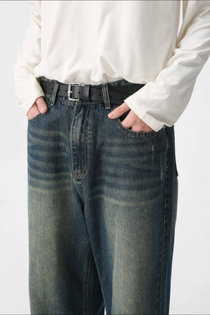 Faded wash wide-leg denim jeans in medium with a relaxed fit and distressed details.
