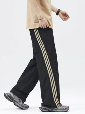 Casual loose fit drawstring pants in noirnoir with triple stripe detail down the leg.