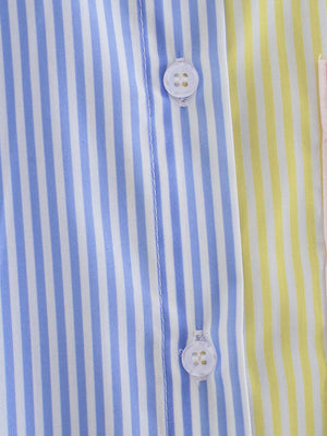 Colorblock striped oversized button-down shirt with blue, yellow, and pink panels and white buttons.