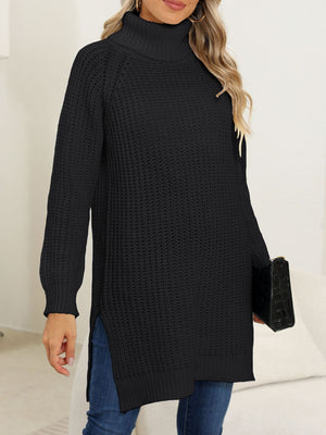 Black knit turtleneck sweater with asymmetric hemline and side slits, styled casually.