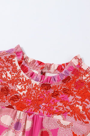 Floral embroidered yoke blouse with ruffle neckline and colorful print.
