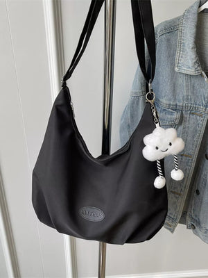 Black canvas shoulder bag with adjustable strap and cute cloud charm detail.