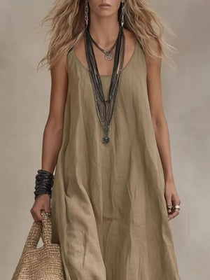 Khaki scoop neck maxi dress with a flowing silhouette, styled with layered necklaces and bracelets.