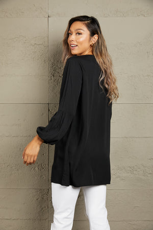 Black oversized blouse with mandarin collar and balloon sleeves