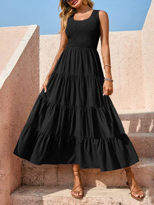 Black smocked bodice ruffled maxi dress with tiered skirt and square neckline.