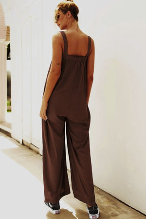 Chocolate square-neck palazzo jumpsuit with wide legs and pockets.
