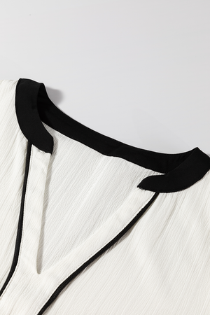 White textured V-neck blouse with black trim detail