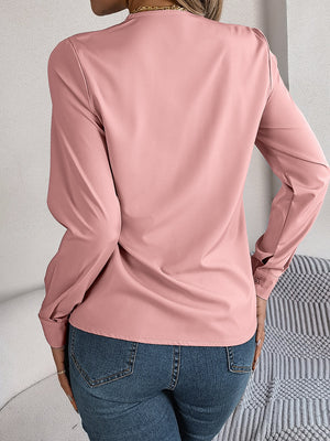 Dusty Pink V-neckline blouse with long sleeves and button cuffs.