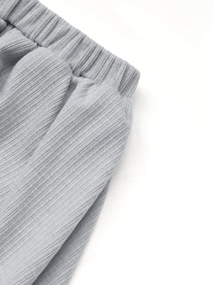 Gray ribbed knit co-ord set detail showing elastic waistband and gathered fabric.