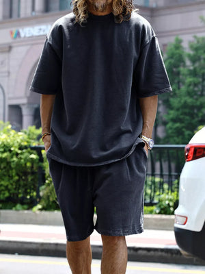 Men's dark gray relaxed fit two-piece set with drawstring shorts and short sleeve tee.