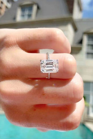 Sparkle Luxe Moissanite Halo Ring in silver with an emerald-cut center stone and diamond band.