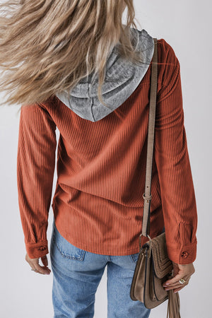 Orange-red corduroy shirt jacket with contrast gray hood and button cuffs.