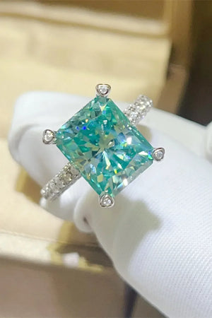 Radiant emerald cut teal pave ring with diamond band.