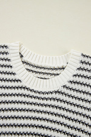 Sleeveless knit tank top in black and white stripe pattern, acrylic material, crew neck.