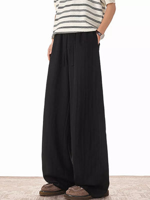 Black relaxed fit drawstring sweatpants with a wide leg and pockets.