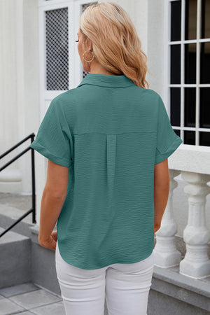 Green textured short sleeve collared shirt with cuffed sleeves and a back pleat detail.