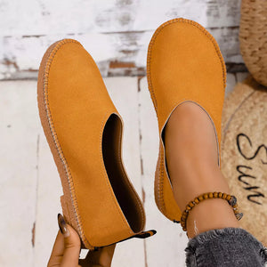 Yellow espadrille-inspired round toe slip-on flats with stitched sole detail.