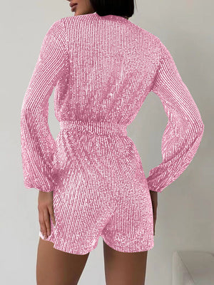 Pink sequin wrap romper with blouson sleeves and cinched waist