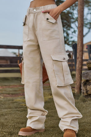 Tan utility cargo pants with wide legs and multiple pockets.
