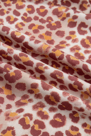 Leopard print dress fabric with ruffled detail and v-neck detail