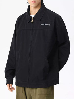Men's black casual zip-up jacket with embroidered text detail on chest