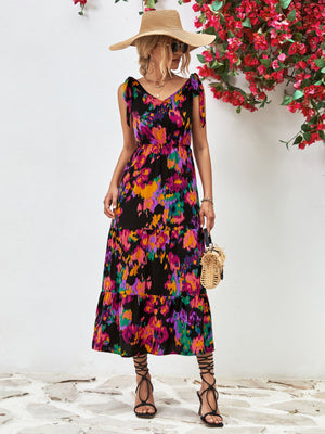 Tie-strap abstract print tiered maxi dress in black with colorful accents.