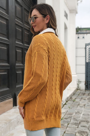 Mustard cable knit longline cardigan with a relaxed fit and crew neck.