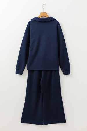 Navy textured polo set with wide-leg culottes and a geometric pattern.