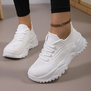 White textured knit sneakers with chunky sole and lace-up front.