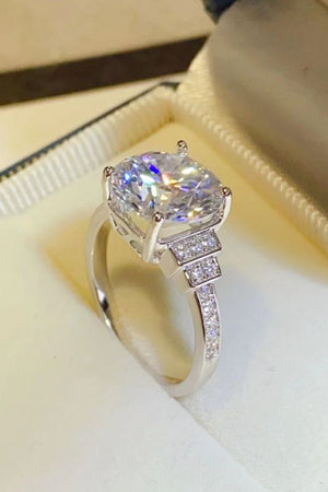 Radiant cut halo sterling ring with pave diamond band and stepped shoulders.